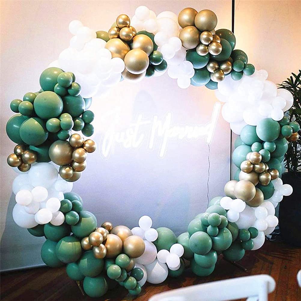 Balloon arch with green, gold, and white balloons in front of a mirror.